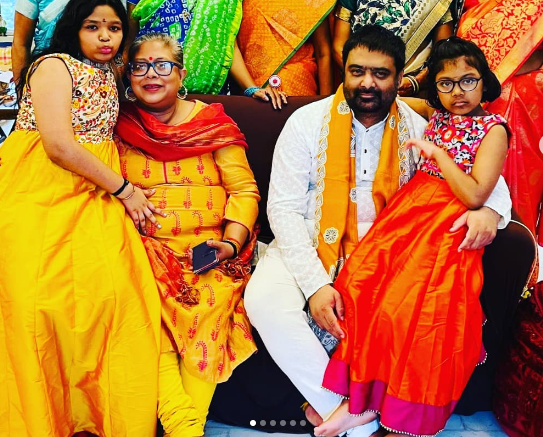 "Deepak Chaurasia standing beside his daughter, both smiling warmly.