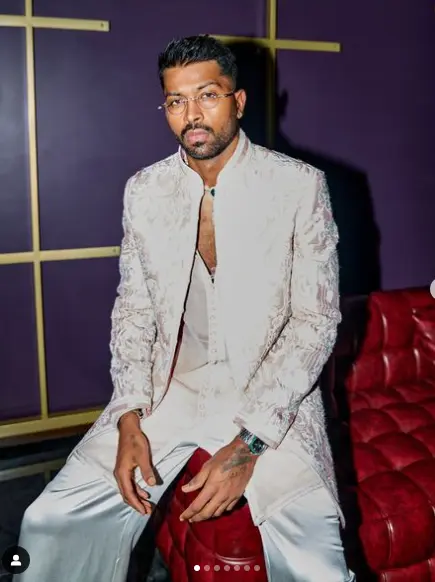 "Hardik Pandya posing in a stylish outfit, showcasing his wealth and success."

