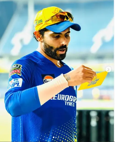 "Ravindra Jadeja standing on the cricket field in his Indian team jersey, emphasizing his impressive height and athletic build."

