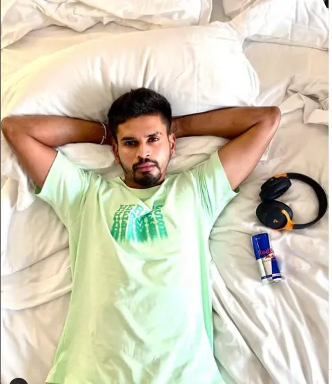 Shreyas Iyer smiling with a cricket bat in hand, showcasing his passion for the sport on Instagram.