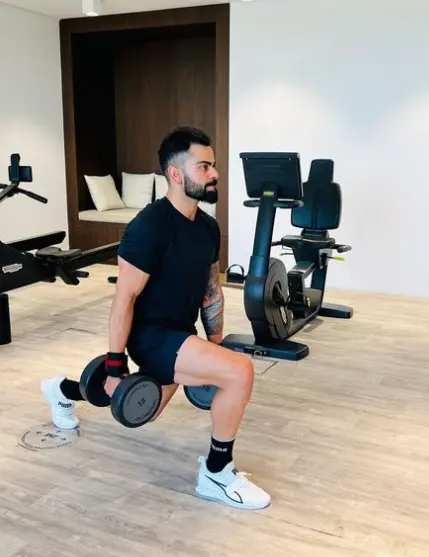 "Virat Kohli smiling and holding a cricket bat, celebrating his birthday on the cricket field."

