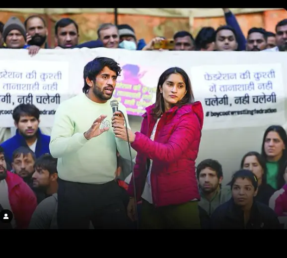 "Vinesh Phogat during a press conference, expressing strong emotions amid a controversy."