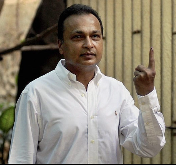 "Portrait of Anil Ambani, an Indian businessman and chairman of Reliance Group, wearing a suit and smiling confidently."