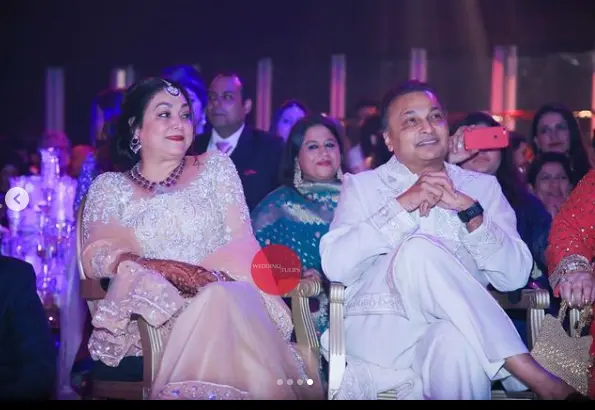 "Tina Ambani, wife of businessman Anil Ambani, wearing an elegant outfit and smiling gracefully."