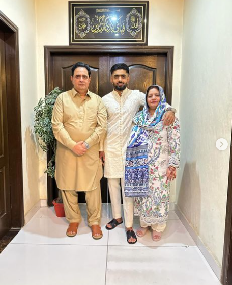 Babar Azam with his family members, smiling together in a close, warm family setting.