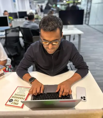 Portrait of Deepinder Goyal, founder and CEO of Zomato, in a formal business attire, standing confidently with a slight smile, symbolizing his leadership in the food-tech industry.

