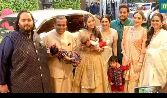 "Photo of Isha Ambani with her family, including her parents, Mukesh and Nita Ambani, and her brothers, Akash and Anant Ambani. The family stands together in coordinated attire, exuding warmth, unity, and their legacy as a prominent business family in India."

