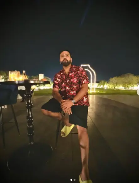 "Rohit Sharma sitting on a bench in casual attire, gazing into the distance, reflecting calmness and confidence."